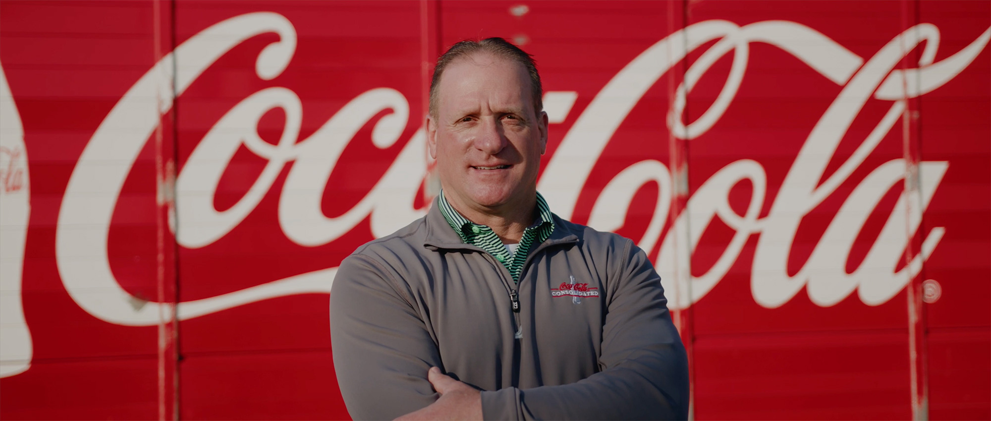 Closeup man standing in front of Coca-Cola truck
